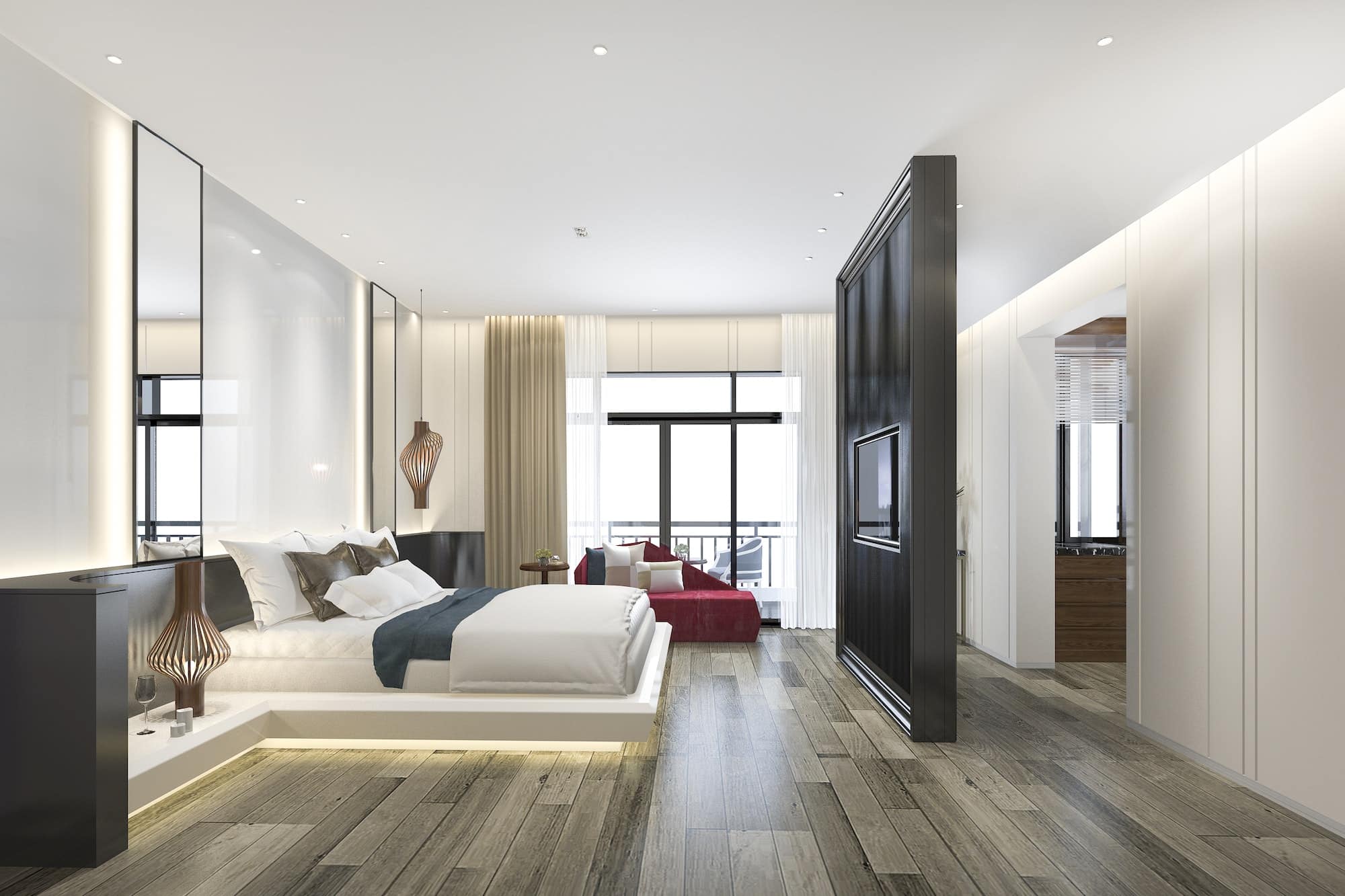 Joachim Schmitt Photography Immobilienfotografie Schöne Luxus Schlafzimmer Suite im Hotel mit Fernseher und rotem Sofa